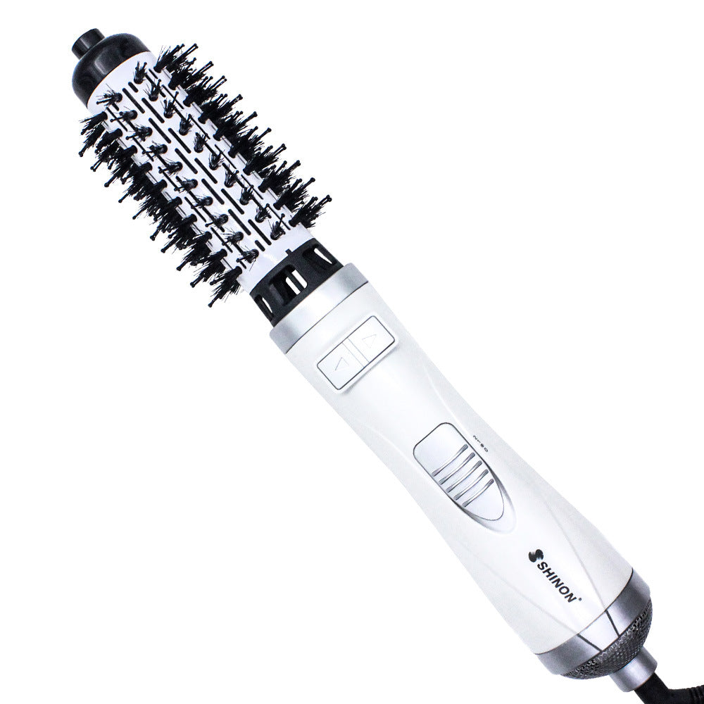 Professional 2-in-1 rotating hot air brush and hair volumizer in white and silver.