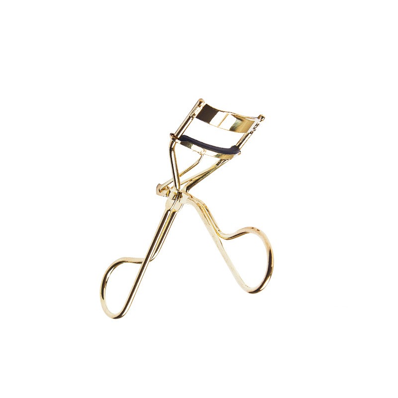 Gold eyelash curler on a white background