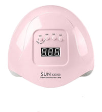 Pink nail lamp with digital display and Australian plug adapter on a white background