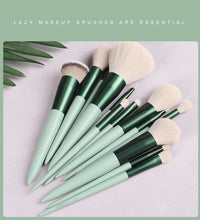 Set of makeup brushes with green handles on a light gray background, accompanied by text 'Lazy makeup brushes are essential'.