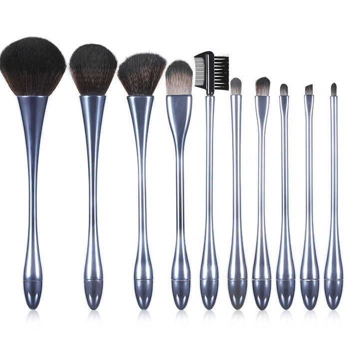 Set of makeup brushes with metallic handles on a white background