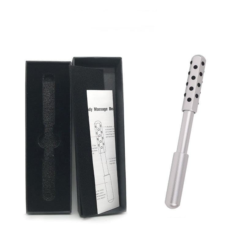 White body massage roller with black dots next to an open black box on a white background