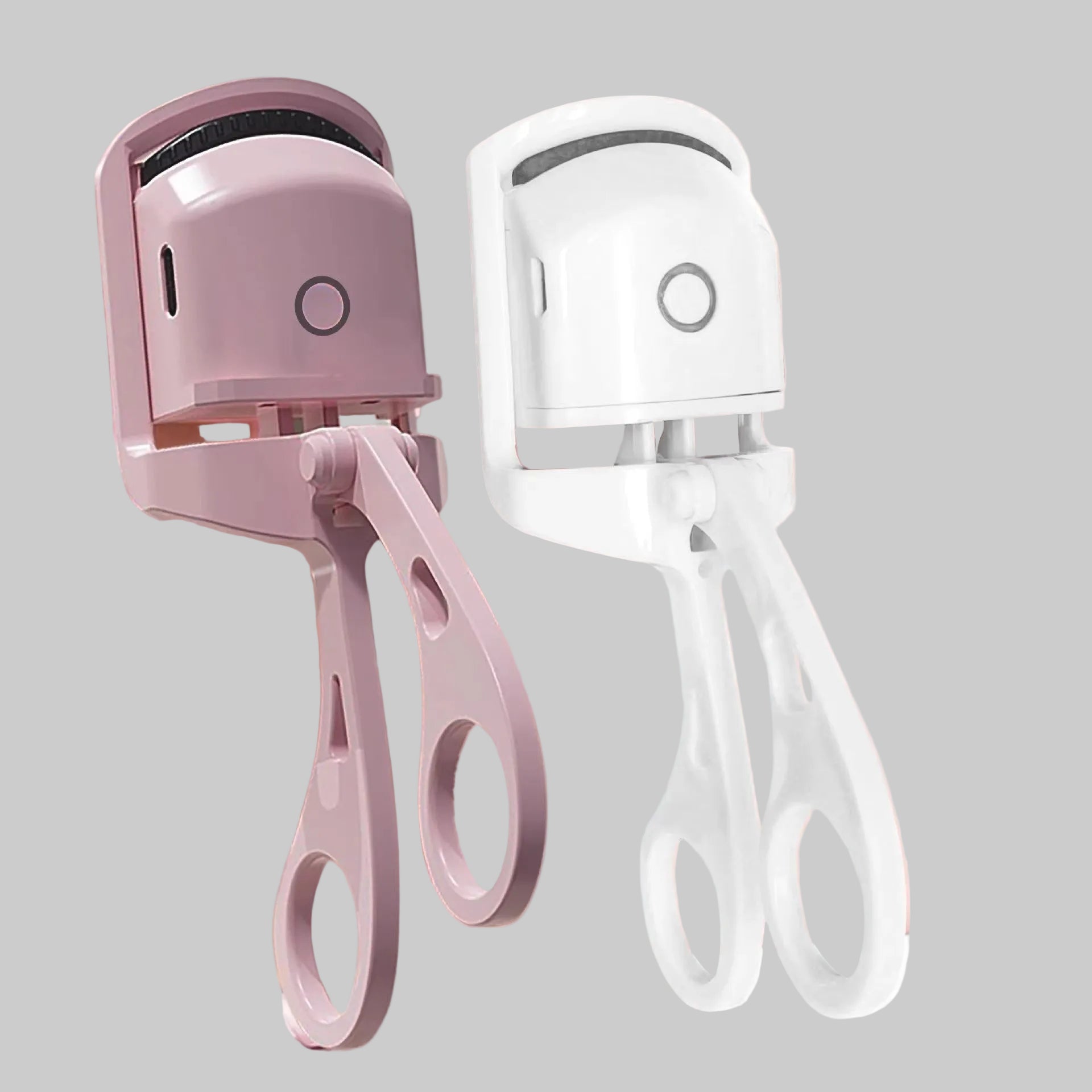 Electric eyelash curler in pink and white on a pink background