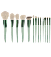 Set of 15 makeup brushes with green handles on a white background